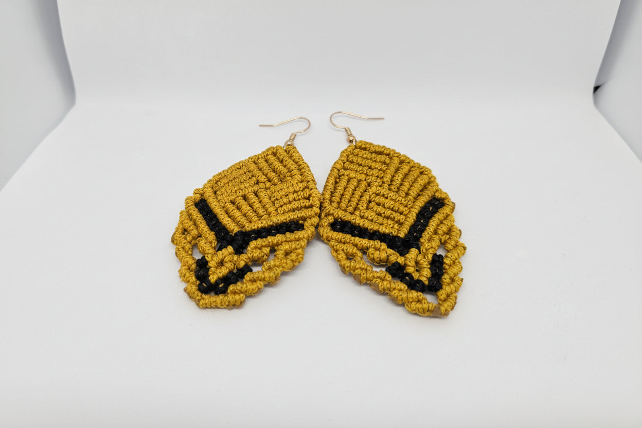 Pair of yellow and black beaded earrings on a white card.